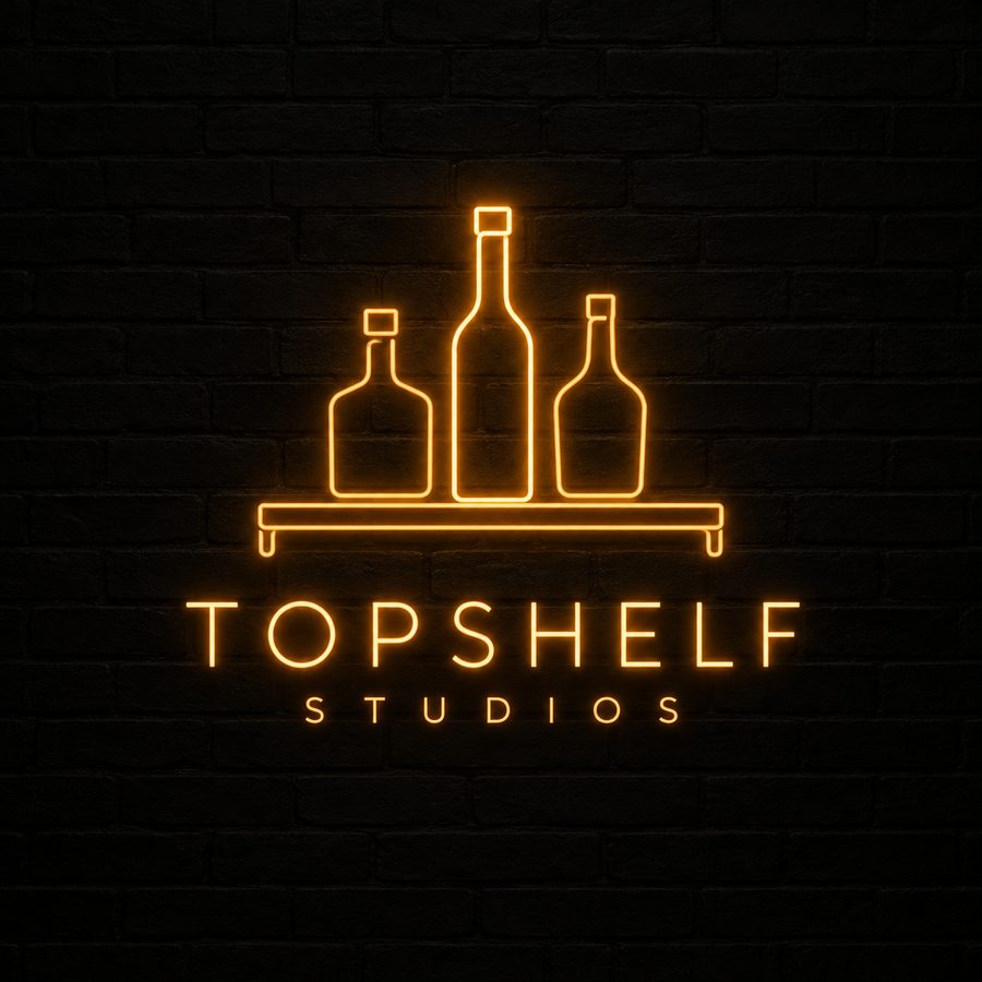 TopShelf Studios neon sign on a brick wall